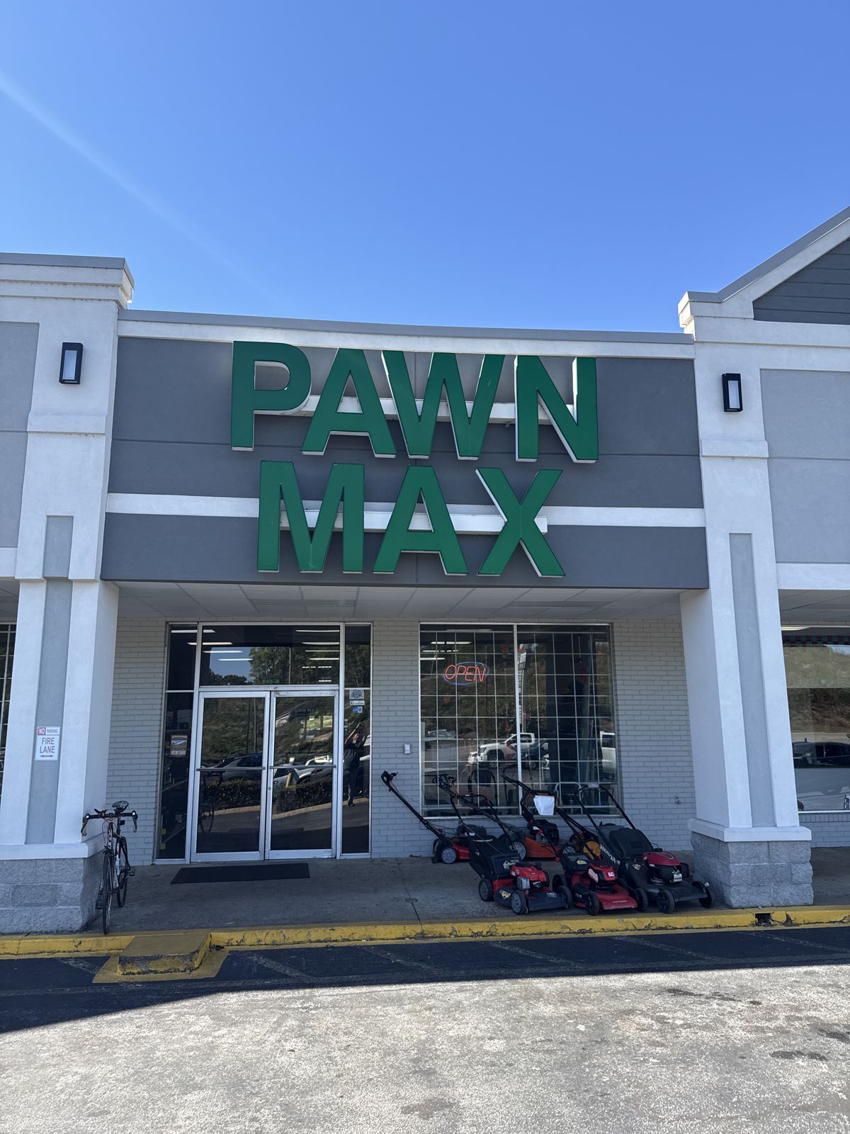 Pawn Max storefront with green sign in Four Lane Shopping Center
